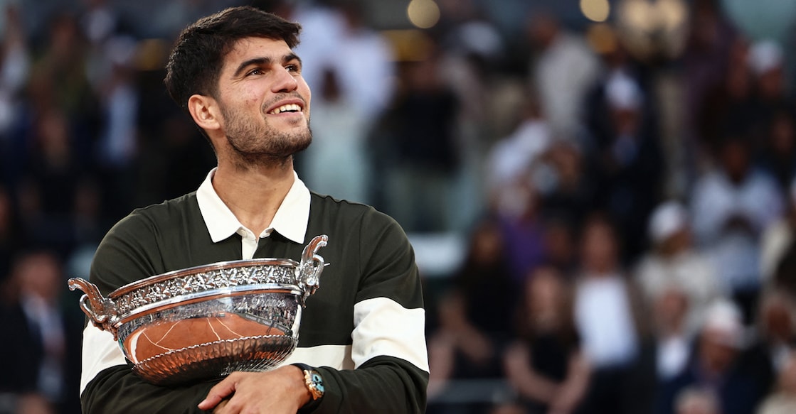 Spain's Carlos Alcaraz holds the trophy after winning the men's singles final match against Italy's Jannik Sinner in the French Open on Court Philippe-Chatrier at the Roland-Garros Complex in Paris on June 8, 2025. Photo: AFP/ Thibaud Moritz